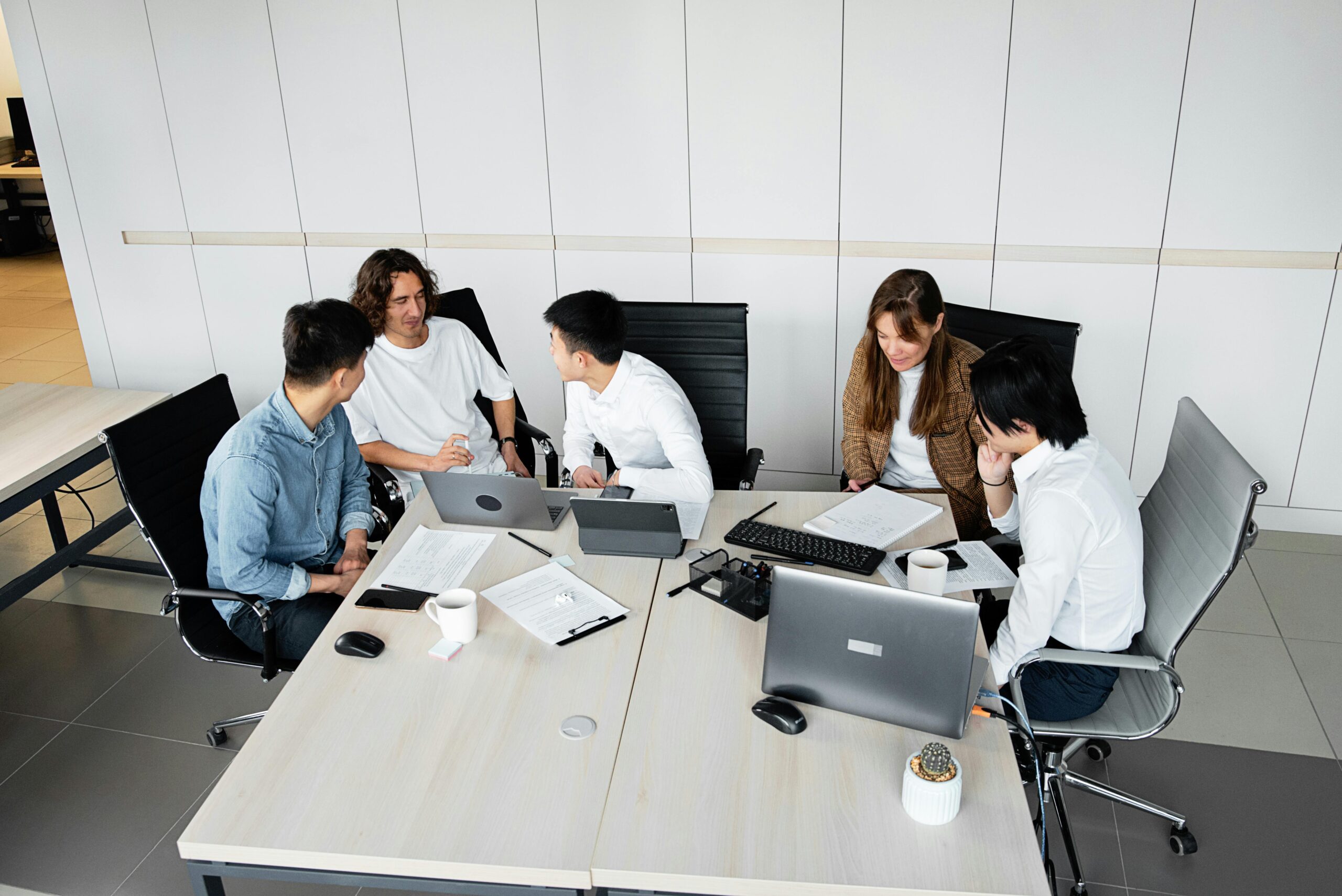 Group of coworkers brainstorming ideas during a collaborative team meeting in a bright office.